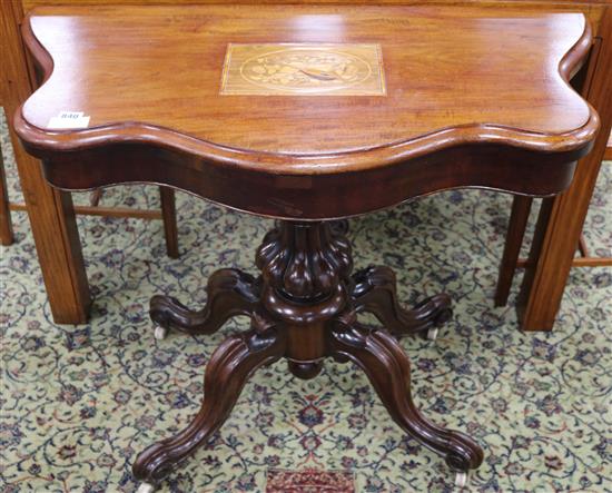 A Victorian mahogany card table, with musical inset panel